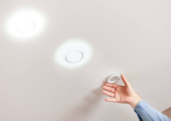 fixing ceiling light. person repairing or replacing ceiling diod light at white background.